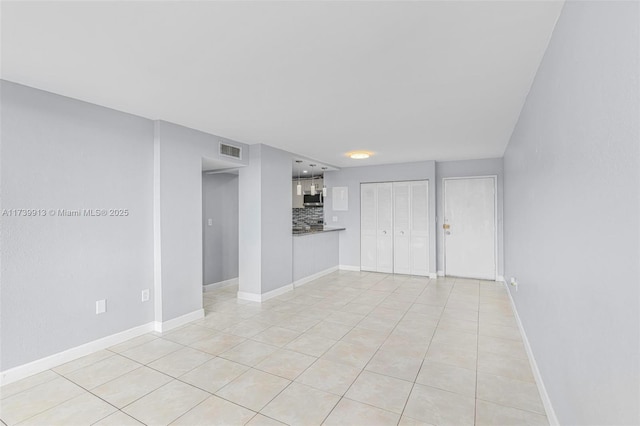 unfurnished living room featuring light tile patterned flooring