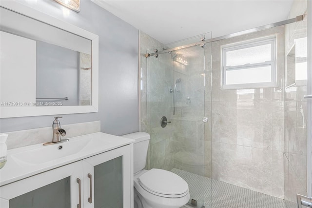 bathroom with vanity, toilet, and a shower with shower door