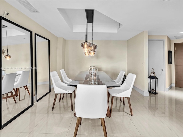 dining area with a raised ceiling