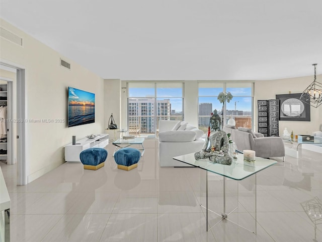 living room with floor to ceiling windows, light tile patterned flooring, and an inviting chandelier