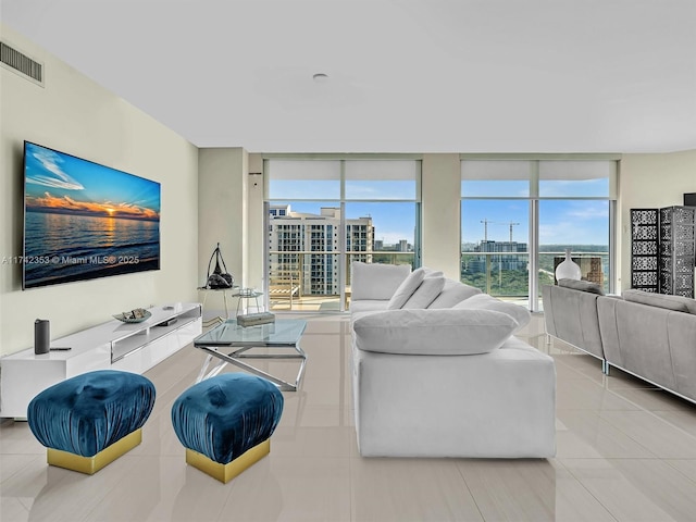 living room with expansive windows and light tile patterned floors