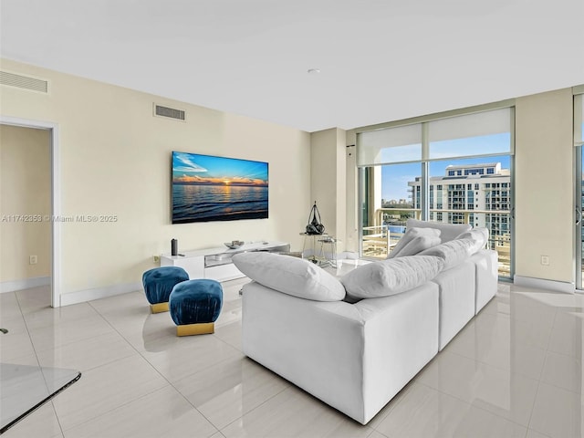 tiled living room with floor to ceiling windows