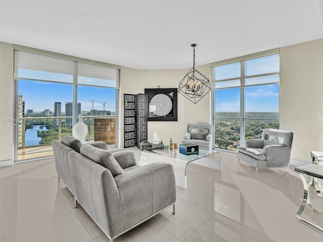 living room featuring a wealth of natural light, a wall of windows, a chandelier, and light tile patterned flooring