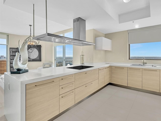 kitchen featuring sink, a wealth of natural light, black electric stovetop, and light brown cabinets