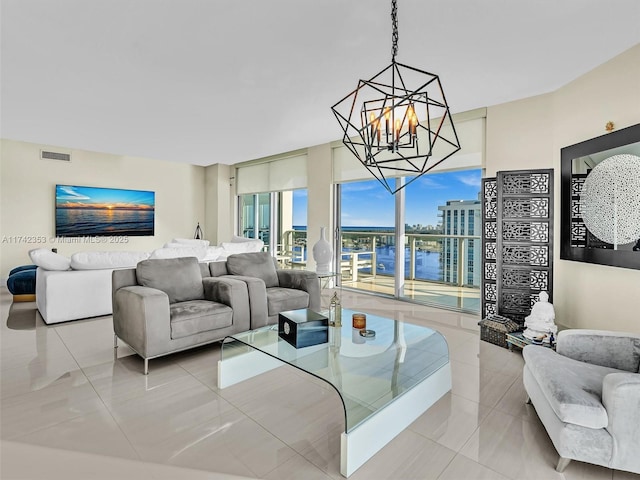 tiled living room with a notable chandelier