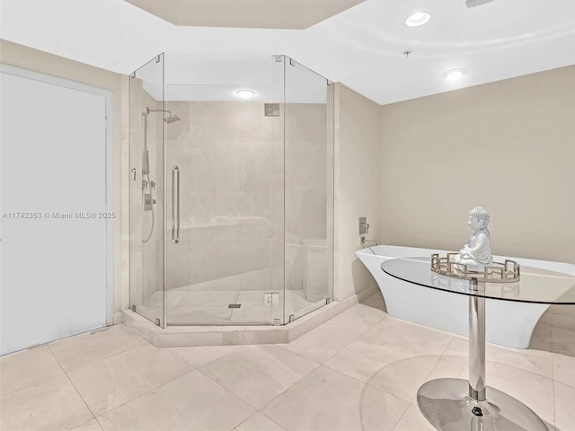 bathroom featuring shower with separate bathtub and tile patterned flooring