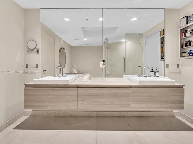 bathroom featuring tile patterned flooring, vanity, and walk in shower