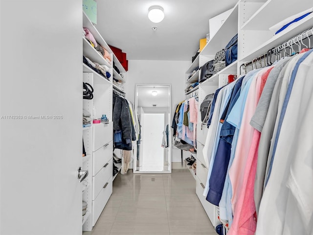 spacious closet with light tile patterned flooring