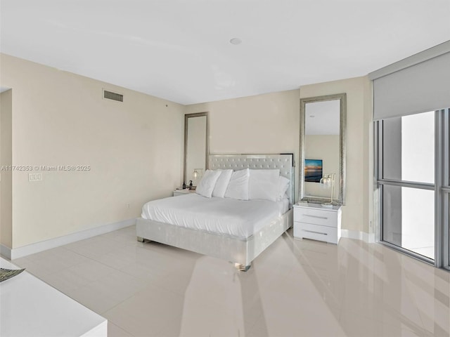 bedroom with light tile patterned floors