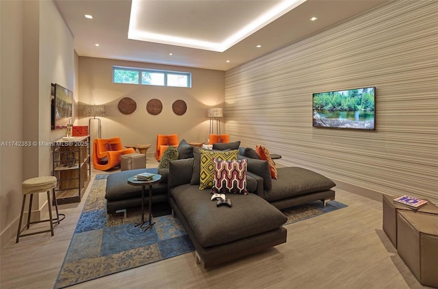 interior space with a tray ceiling and light hardwood / wood-style floors