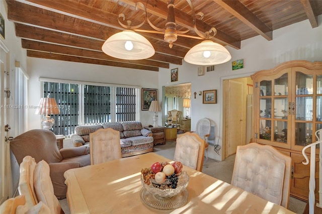 carpeted dining space featuring wooden ceiling and beam ceiling