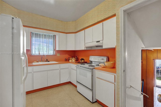 kitchen with white cabinetry, white appliances, and sink