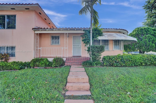 mediterranean / spanish-style home with a front yard