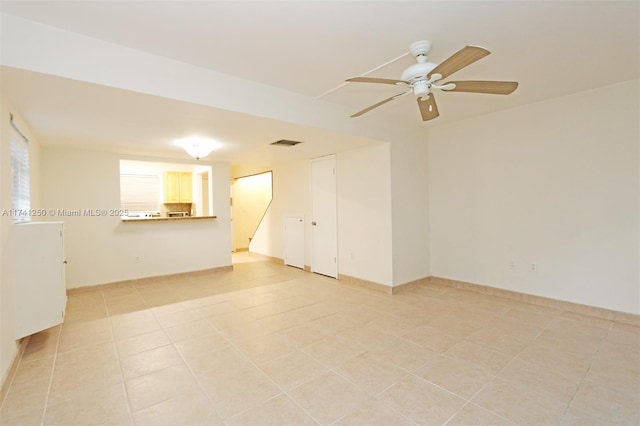 tiled empty room with ceiling fan