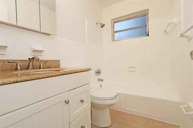 full bathroom featuring tile walls, vanity, toilet, tile patterned floors, and washtub / shower combination