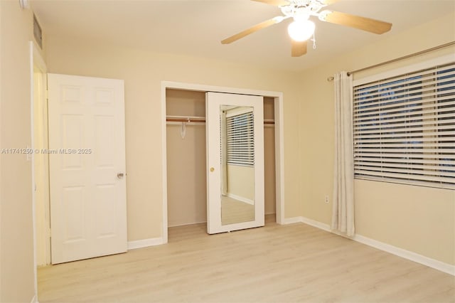 unfurnished bedroom featuring light hardwood / wood-style flooring, a closet, and ceiling fan