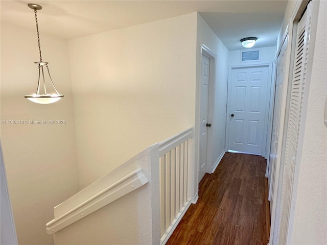 hall with dark wood-style flooring and visible vents