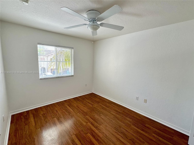 unfurnished room with baseboards, ceiling fan, wood finished floors, and a textured ceiling