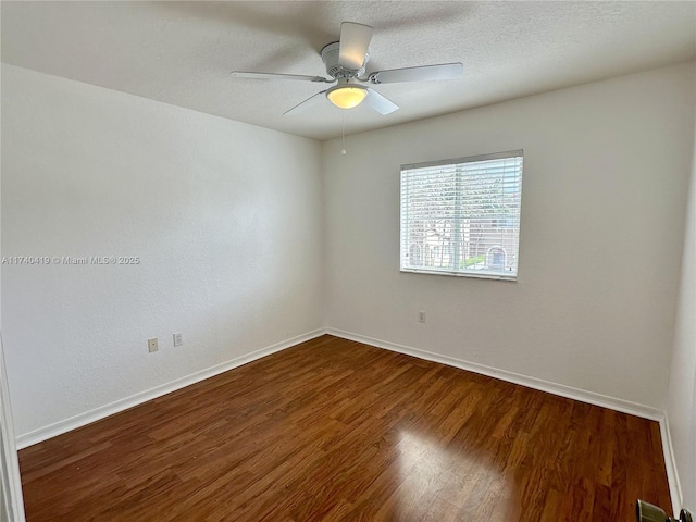 spare room with ceiling fan, baseboards, a textured ceiling, and wood finished floors