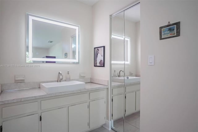 bathroom with vanity and tile patterned flooring