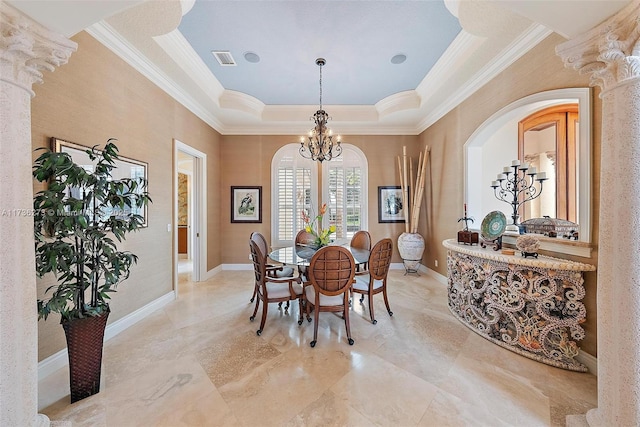 dining room featuring ornamental molding, a chandelier, decorative columns, and a raised ceiling