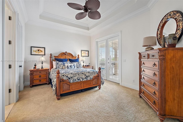 carpeted bedroom with access to exterior, a tray ceiling, ornamental molding, and ceiling fan