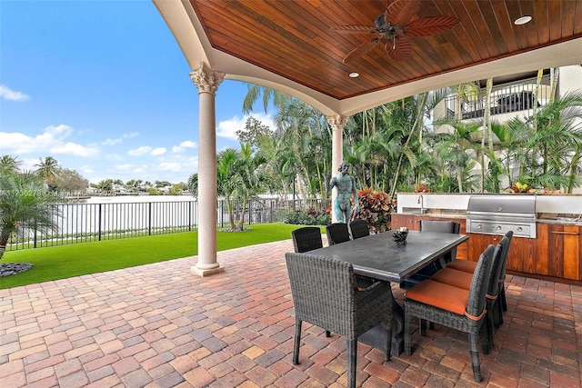 view of patio / terrace with ceiling fan, area for grilling, an outdoor kitchen, and sink