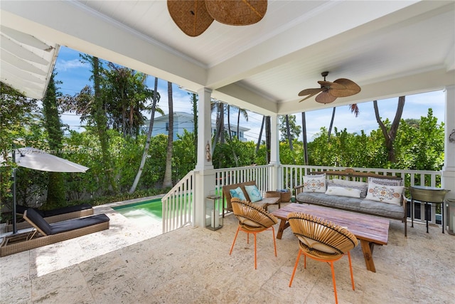 sunroom / solarium featuring ceiling fan