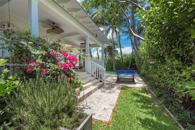 view of yard featuring ceiling fan and a porch