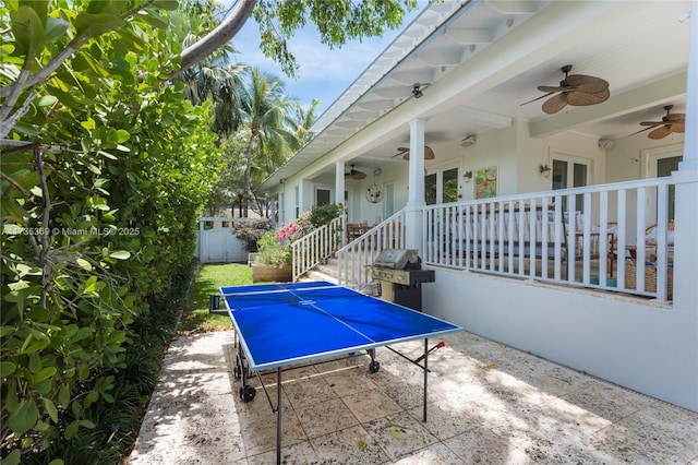 view of patio with ceiling fan and a grill