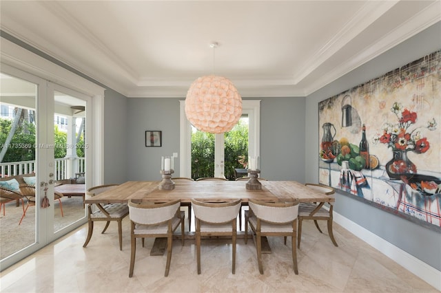 tiled dining area featuring crown molding, plenty of natural light, and french doors