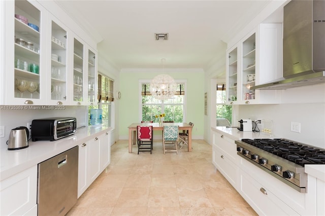 kitchen with white cabinetry, wall chimney exhaust hood, stainless steel gas stovetop, and pendant lighting