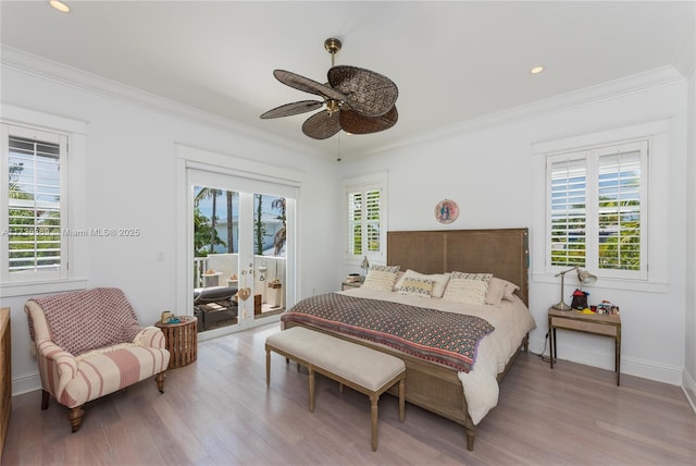 bedroom with multiple windows, crown molding, and access to outside