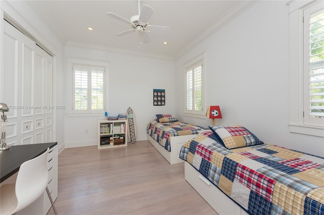 bedroom with ceiling fan, ornamental molding, and light hardwood / wood-style floors