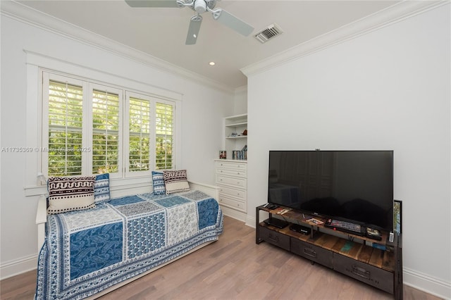 bedroom featuring hardwood / wood-style flooring, ceiling fan, and ornamental molding