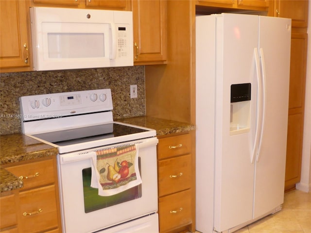 kitchen with tasteful backsplash, light tile patterned floors, white appliances, and stone countertops