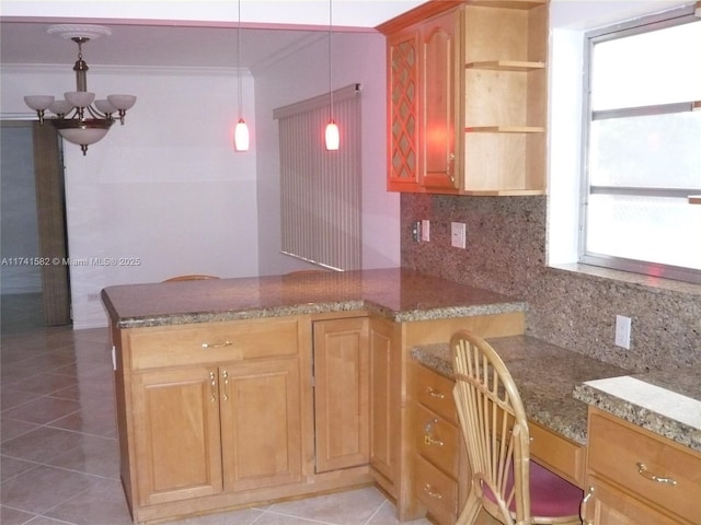 kitchen with decorative backsplash, hanging light fixtures, light tile patterned floors, kitchen peninsula, and an inviting chandelier