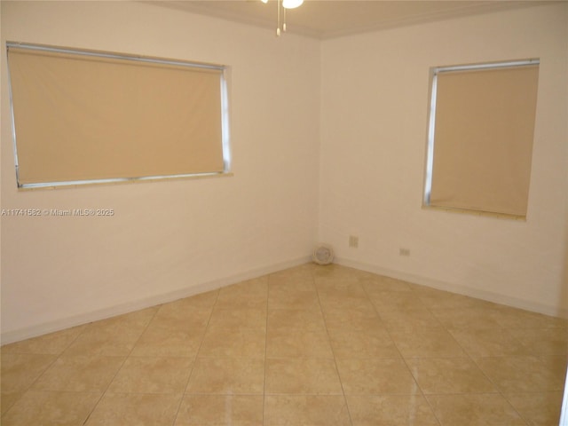 spare room with light tile patterned floors and ceiling fan