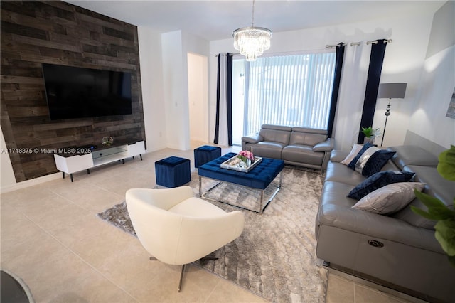 living area with tile patterned flooring, a chandelier, and baseboards