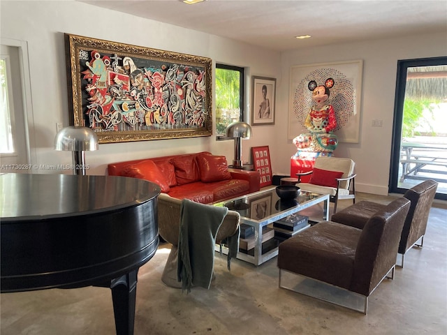 living room with concrete flooring and a healthy amount of sunlight