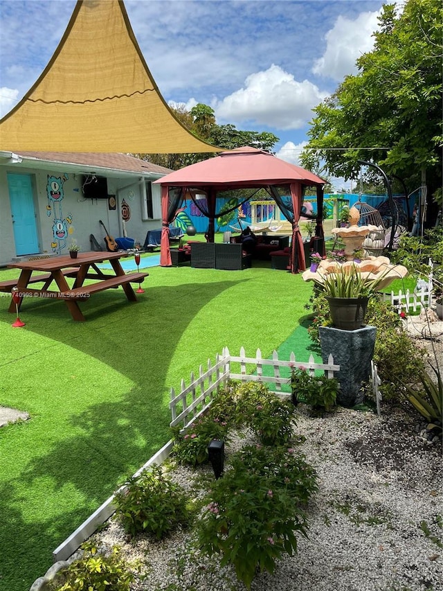 view of home's community with a gazebo, an outdoor hangout area, and a lawn