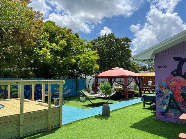 5895 NW 12th Ave, Miami, FL 33127 - view of play area with a gazebo, a deck, and a lawn