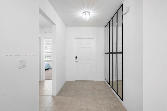 hall featuring light tile patterned floors