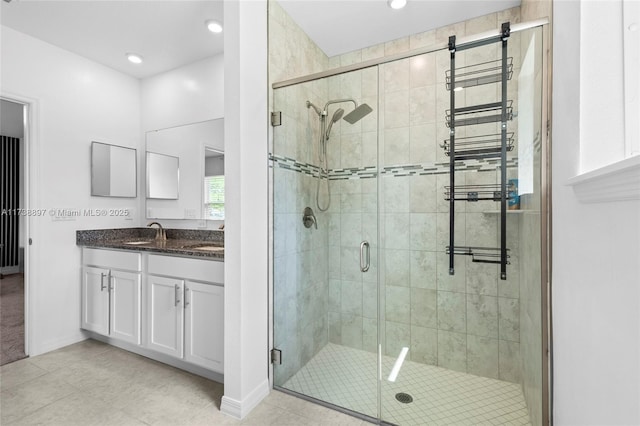 bathroom featuring vanity and a shower with shower door