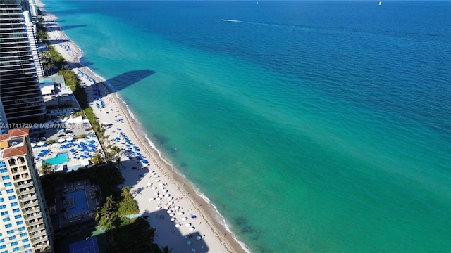 birds eye view of property featuring a water view and a beach view