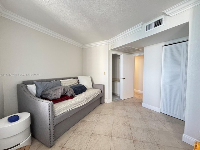 bedroom with crown molding and a textured ceiling