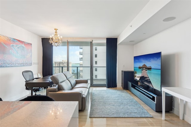 living room with light wood-type flooring, a chandelier, and expansive windows