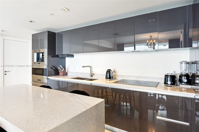 kitchen featuring sink, black electric stovetop, wall chimney range hood, and stainless steel double oven