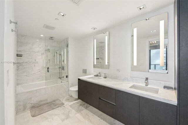 full bathroom featuring toilet, vanity, and tiled shower / bath combo