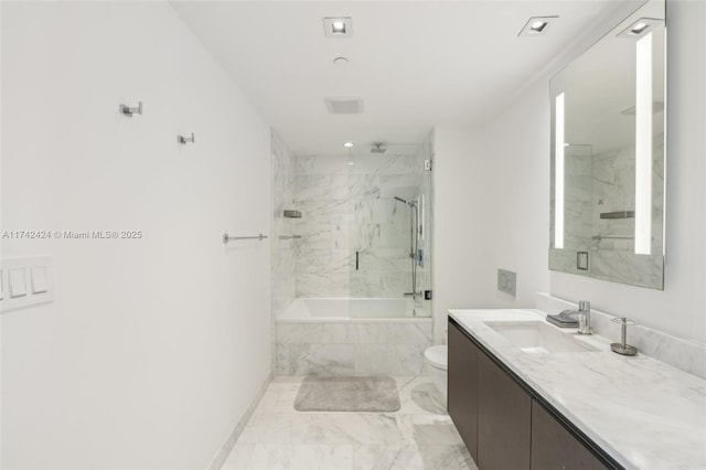 full bathroom featuring toilet, vanity, and tiled shower / bath combo